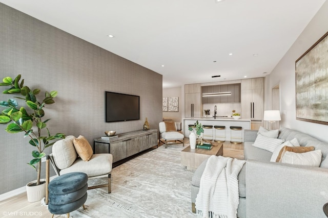 living area featuring recessed lighting, wallpapered walls, and light wood-style flooring
