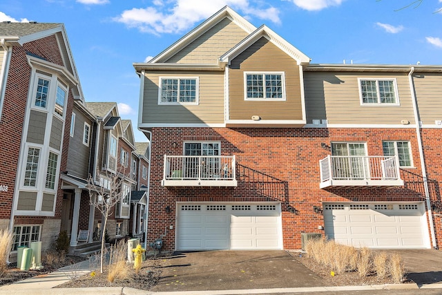 412 N Cass St Unit 4, Westmont, IL 60559 - view of property with an attached garage, brick siding, and aphalt driveway
