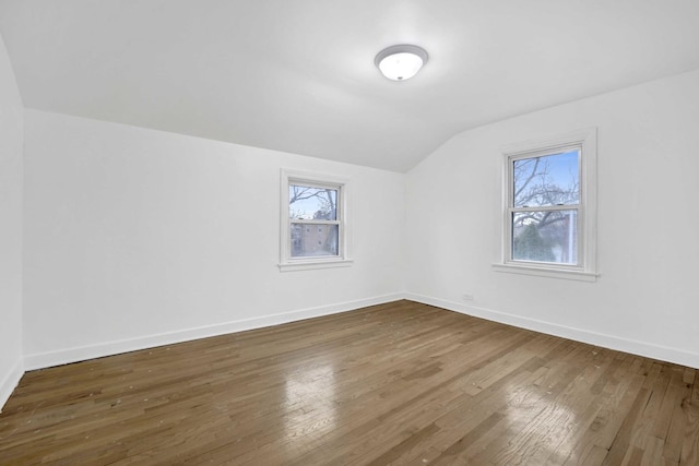 2232 S 2nd Ave, North Riverside, IL 60546 - interior space featuring white appliances, light wood-type flooring, a peninsula, baseboards, and arched walkways