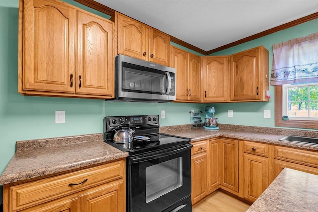 3504 Royal Oak Ct, Champaign, IL 61822 - kitchen featuring stainless steel microwave, black range with electric cooktop, crown molding, and light wood-type flooring