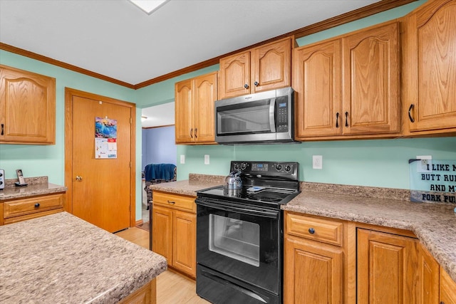 3504 Royal Oak Ct, Champaign, IL 61822 - kitchen featuring stainless steel microwave, black / electric stove, light wood-style floors, light countertops, and ornamental molding