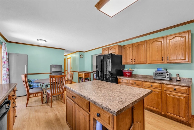 3504 Royal Oak Ct, Champaign, IL 61822 - kitchen featuring black appliances, light wood finished floors, ornamental molding, a kitchen island, and brown cabinetry