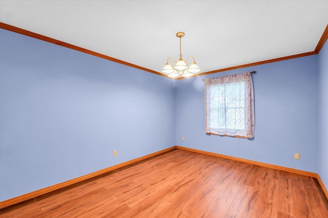 3504 Royal Oak Ct, Champaign, IL 61822 - spare room featuring ornamental molding, a chandelier, and wood finished floors