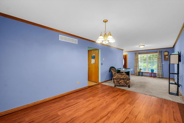 3504 Royal Oak Ct, Champaign, IL 61822 - unfurnished living room with a chandelier, crown molding, and wood finished floors