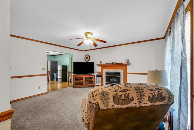 3504 Royal Oak Ct, Champaign, IL 61822 - living room with ceiling fan, carpet, crown molding, and a tiled fireplace