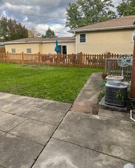 view of yard with a fenced front yard and cooling unit