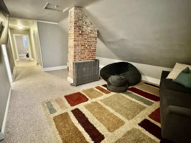 carpeted bedroom featuring baseboards, radiator, attic access, and vaulted ceiling