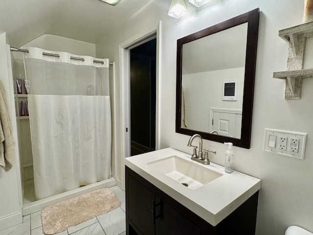 bathroom with marble finish floor, a stall shower, and vanity