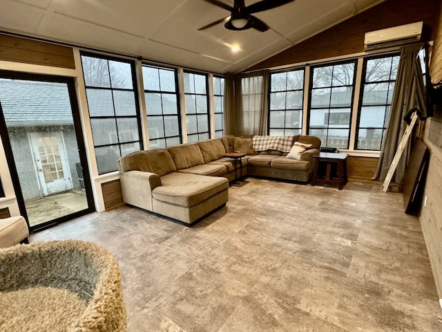 living room featuring lofted ceiling, a healthy amount of sunlight, a ceiling fan, and a wall mounted AC