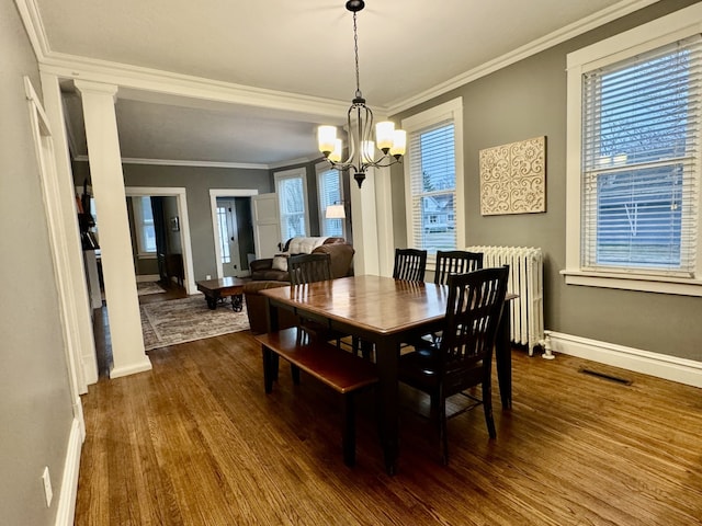 dining room with ornamental molding, radiator, baseboards, a chandelier, and dark wood-style flooring