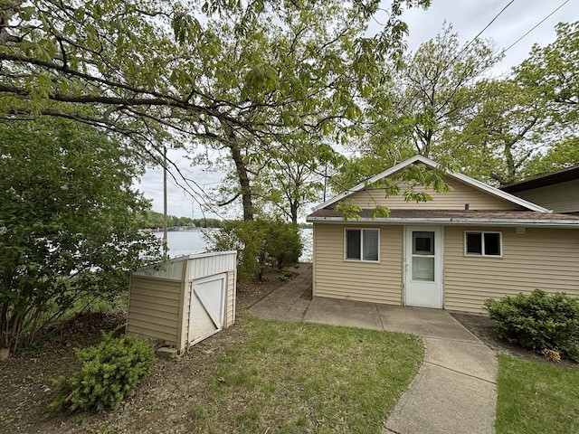 24109 64th Pl, Paddock Lake, WI 53168 - view of green lawn with a patio area and a water view