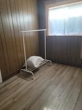 24109 64th Pl, Paddock Lake, WI 53168 - empty room with plenty of natural light, wood finished floors, and wooden walls