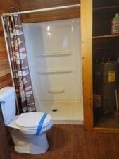 24109 64th Pl, Paddock Lake, WI 53168 - bathroom featuring a stall shower, toilet, and wood finished floors