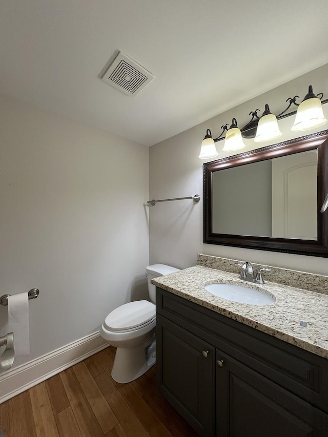 1108 N Devonshire Rd, Buffalo Grove, IL 60089 - bathroom featuring vanity, wood finished floors, baseboards, and toilet