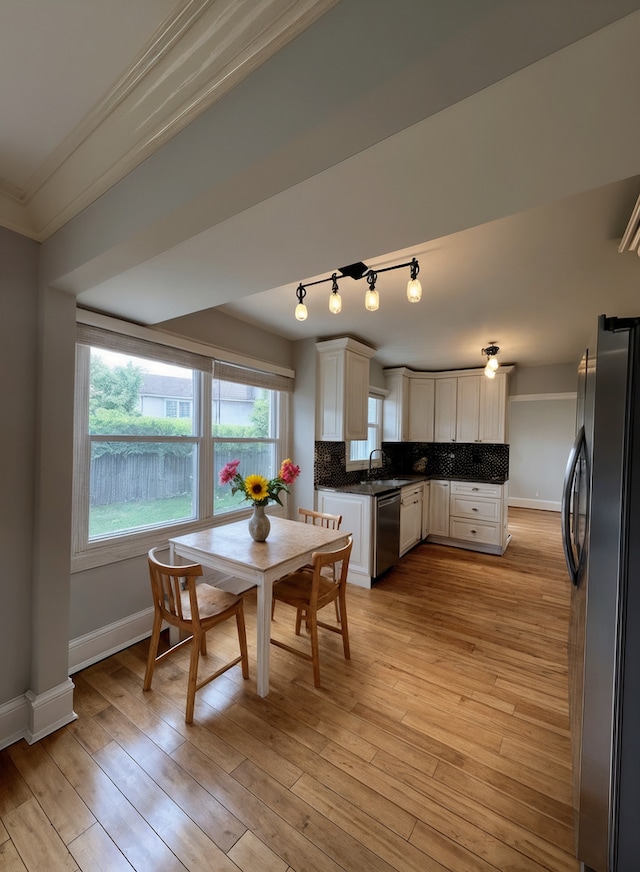 1108 N Devonshire Rd, Buffalo Grove, IL 60089 - kitchen with appliances with stainless steel finishes, ornamental molding, a sink, white cabinets, and tasteful backsplash