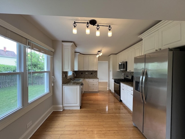 1108 N Devonshire Rd, Buffalo Grove, IL 60089 - kitchen with appliances with stainless steel finishes, plenty of natural light, and tasteful backsplash