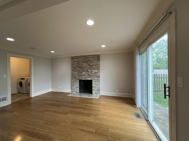 1108 N Devonshire Rd, Buffalo Grove, IL 60089 - unfurnished living room with independent washer and dryer, ornamental molding, light wood finished floors, baseboards, and a stone fireplace
