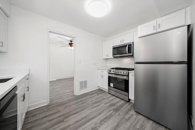 kitchen featuring visible vents, ceiling fan, white cabinetry, and stainless steel appliances