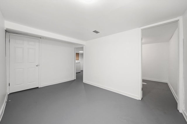 unfurnished bedroom featuring concrete flooring, baseboards, and visible vents