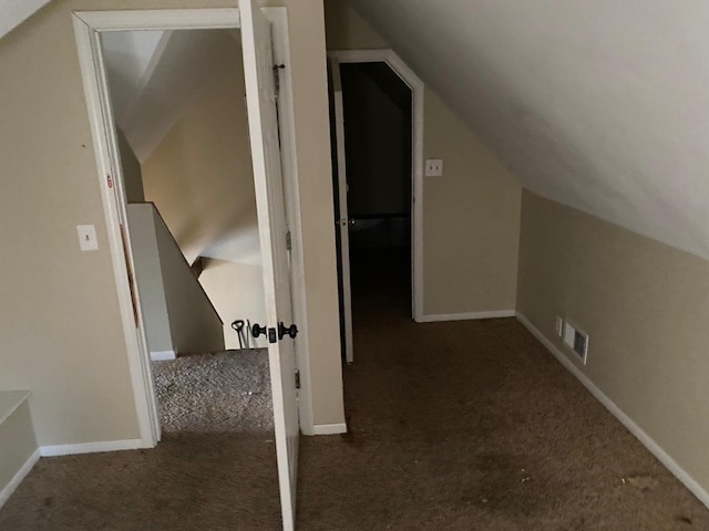 additional living space with lofted ceiling, carpet, visible vents, and baseboards