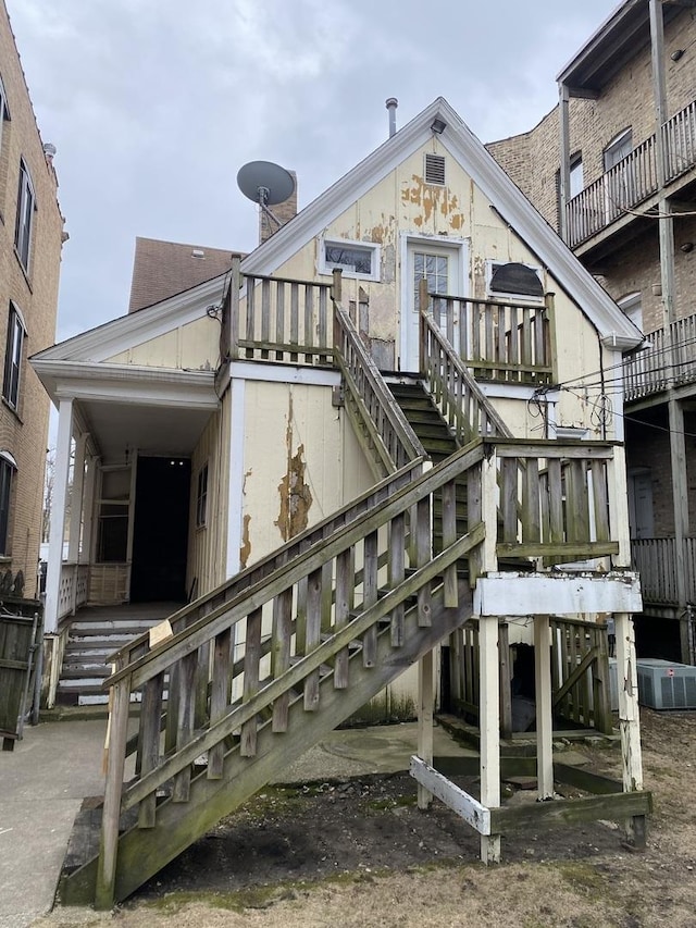 rear view of property featuring stairs