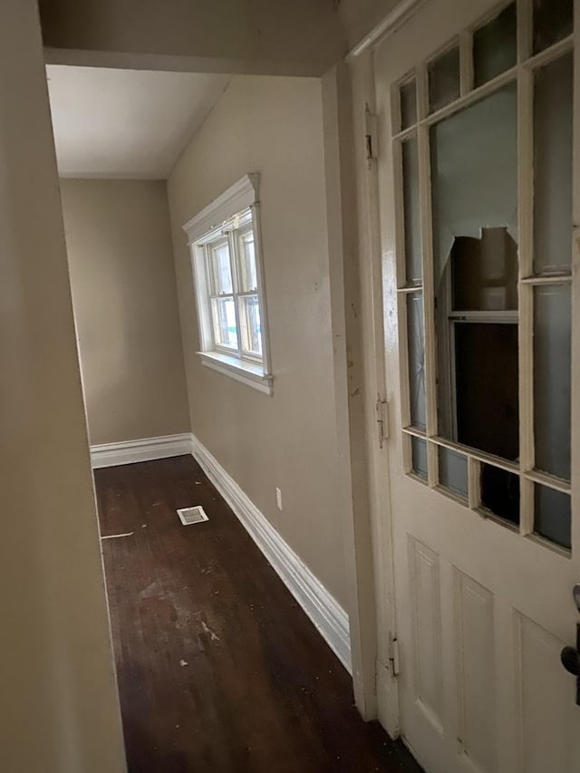 interior space featuring wood finished floors, visible vents, and baseboards