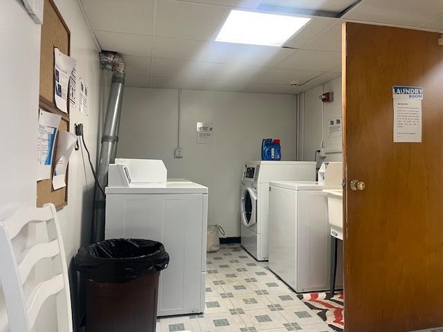 community laundry room with separate washer and dryer and light flooring