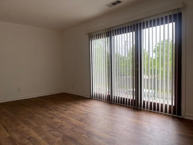 empty room with wood finished floors and baseboards