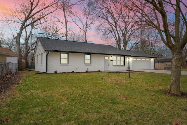 ranch-style home with brick siding, fence, concrete driveway, a front yard, and an attached garage
