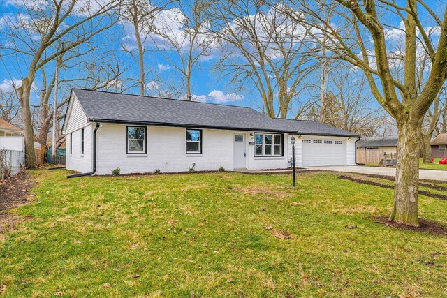 ranch-style home with a front lawn, fence, concrete driveway, a garage, and brick siding