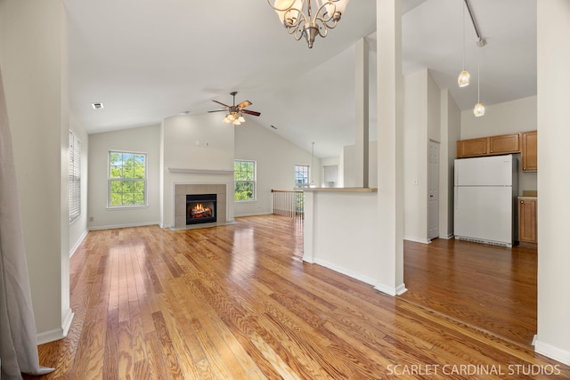 2319 Georgetown Ct, Aurora, IL 60503 - unfurnished living room featuring light wood-style flooring, a ceiling fan, a fireplace, and high vaulted ceiling