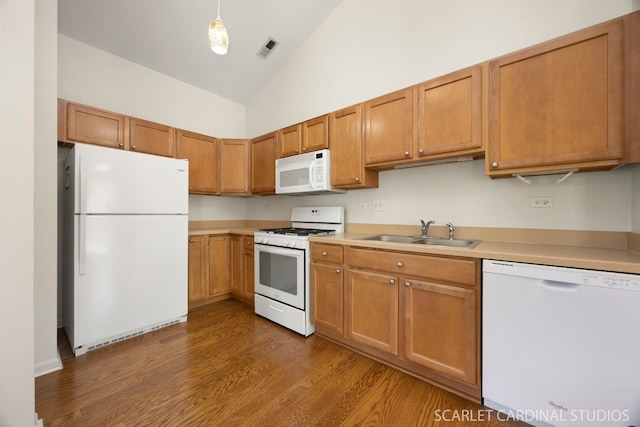 2319 Georgetown Ct, Aurora, IL 60503 - kitchen featuring white appliances, light countertops, wood finished floors, high vaulted ceiling, and brown cabinets