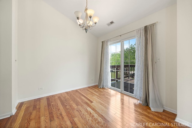 2319 Georgetown Ct, Aurora, IL 60503 - empty room with a chandelier, wood finished floors, and vaulted ceiling