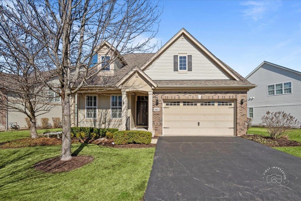 1682 Havenshire Rd, Aurora, IL 60505 - view of front of property featuring a front lawn, driveway, and brick siding