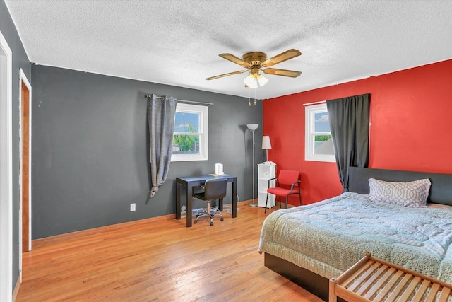 313 W Church St, Savoy, IL 61874 - bedroom with ceiling fan, a textured ceiling, multiple windows, and wood finished floors