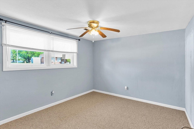313 W Church St, Savoy, IL 61874 - carpeted empty room featuring a ceiling fan, baseboards, and a wealth of natural light