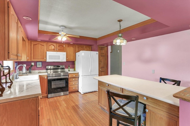 313 W Church St, Savoy, IL 61874 - kitchen with a kitchen breakfast bar, a ceiling fan, a sink, light countertops, and white appliances