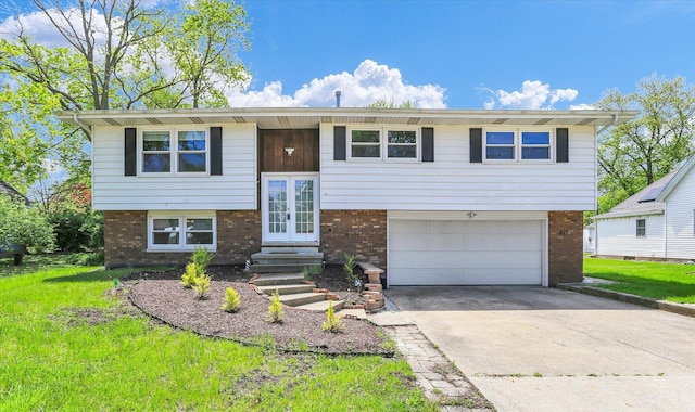 313 W Church St, Savoy, IL 61874 - raised ranch with french doors, an attached garage, driveway, and brick siding