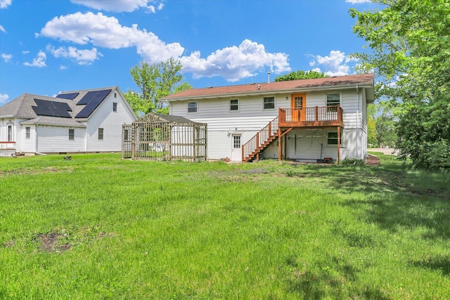 313 W Church St, Savoy, IL 61874 - rear view of house featuring a lawn, a wooden deck, and stairs