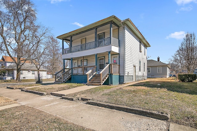 view of front of property featuring a porch and a balcony