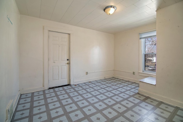 empty room with visible vents, baseboards, and light floors
