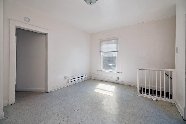 unfurnished room with a baseboard heating unit