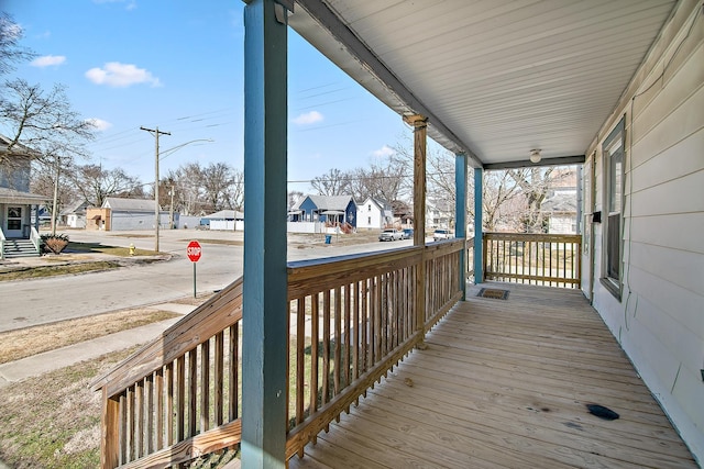 deck with covered porch and a residential view