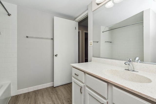 254 E Bailey Rd Unit M, Naperville, IL 60565 - bathroom featuring baseboards, wood finished floors,  shower combination, and vanity