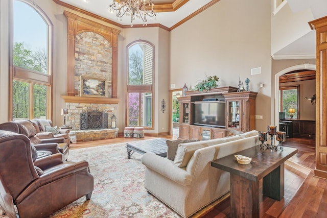 831 Alberosky Way, Batavia, IL 60510 - living area featuring a towering ceiling, wood finished floors, arched walkways, plenty of natural light, and a chandelier