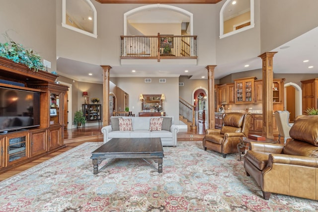 831 Alberosky Way, Batavia, IL 60510 - living room featuring ornate columns, a high ceiling, recessed lighting, crown molding, and light wood-style floors
