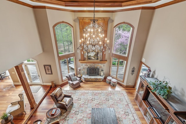 831 Alberosky Way, Batavia, IL 60510 - living area with a fireplace, a high ceiling, healthy amount of natural light, light wood finished floors, and a chandelier