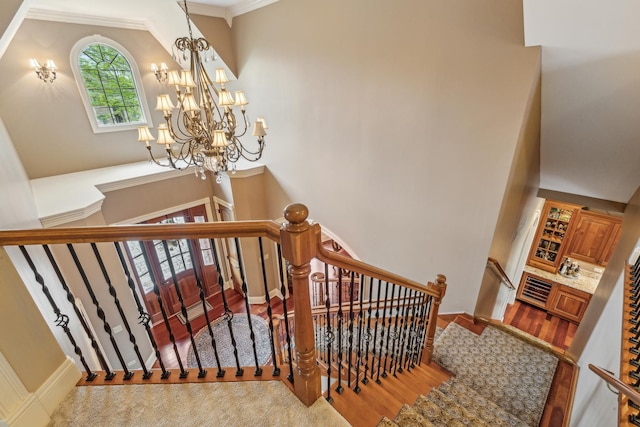 831 Alberosky Way, Batavia, IL 60510 - stairway featuring wood finished floors, a chandelier, ornamental molding, and baseboards