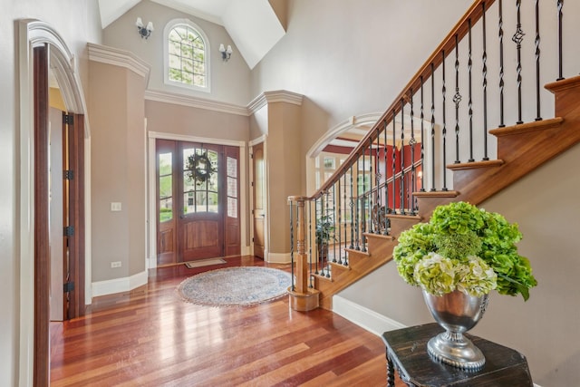 831 Alberosky Way, Batavia, IL 60510 - foyer entrance with a high ceiling, baseboards, wood finished floors, stairway, and arched walkways
