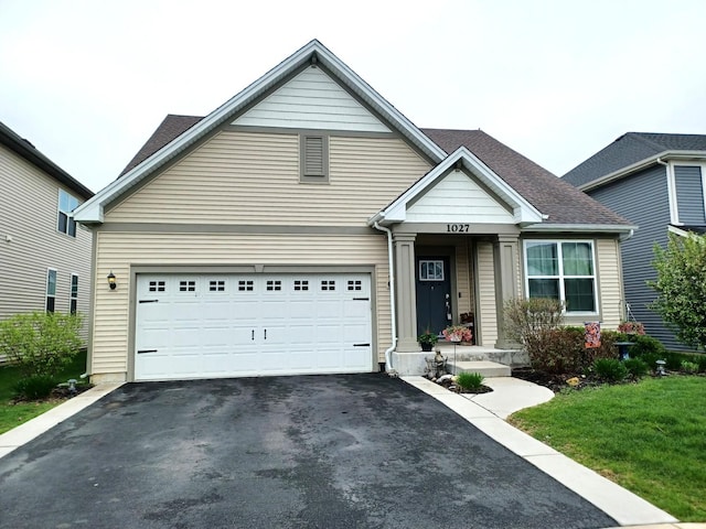1027 Blazing Star St, South Elgin, IL 60177 - traditional home featuring aphalt driveway, a garage, a shingled roof, and a front yard